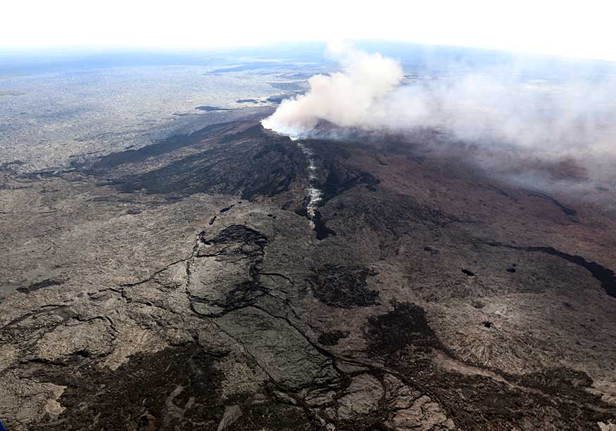 The Kilauea Volcano fissure that formed on the west flank of the Pu'u 'O'o cone (line of white steam) is seen in this aerial image after the volcano erupted. (Image: Reuters)