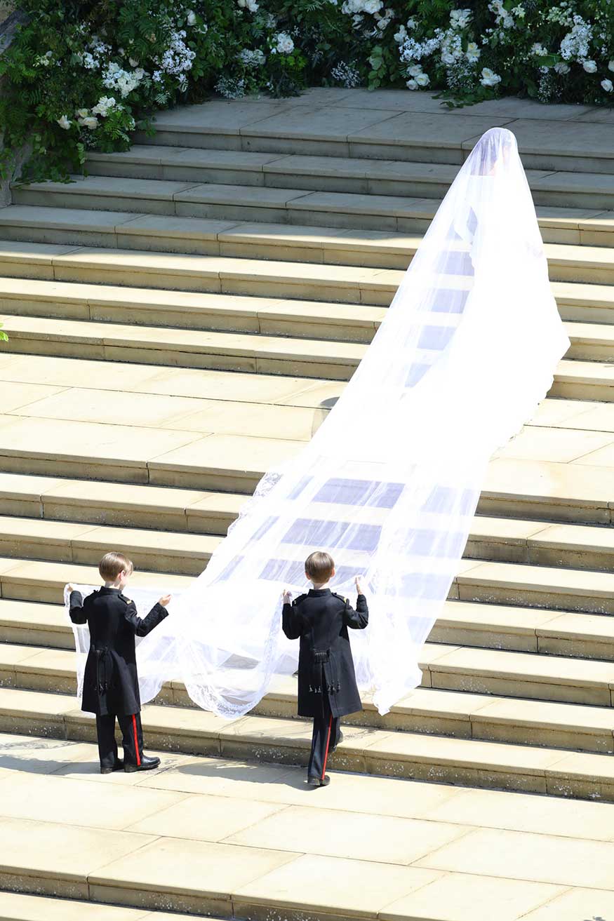 Meghan Markle climbs the stair to the St George's Chapel, Windsor Castle, for the wedding ceremony. (Image: AP)