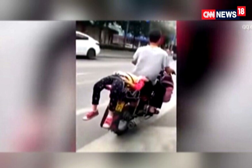Watch: Father Straps His Crying Daughter on Motorcycle, Drives Her to