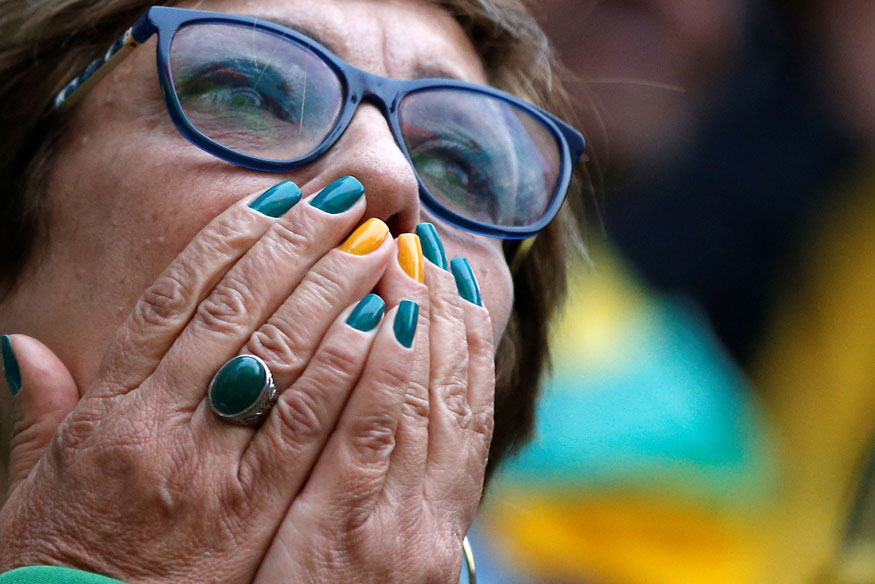 A fan reacts as she watches the broadcast of the FIFA World Cup Group E soccer match between Brazil and Switzerland. (Image: Reuters)