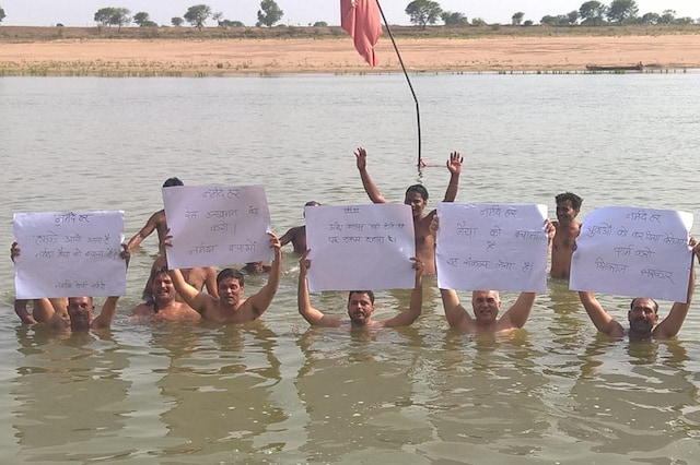 Scores of activists and political leaders stood chest-deep in the river for two hours to protest against MP CM Shivraj Singh Chauhan 
