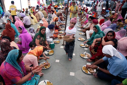 Devotees eat at a langar in a gurudwara in Chandigarh. (Reuters) Devotees eat at a langar in a gurudwara in Chandigarh. (Reuters)
