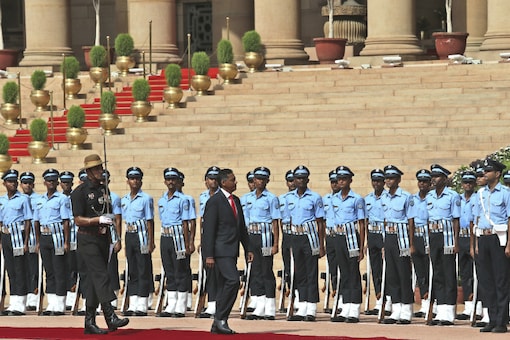 Seychelles President Danny Antoine Rollen Faure inspects a joint military forces guard of honour during his ceremonial reception at the Rashtrapati Bhavan on Monday. (AP)