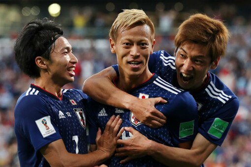 Japan's Keisuke Honda celebrates with teammates after scoring the equaliser against Senegal (Image: FIFA)