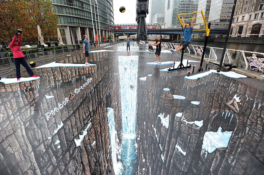 Actors pose with gym equipment on what the Guinness World Records bills as the world's largest 3D painting, at Canary Wharf in London. British artist Joe Hill's creation measures in excess of 1120 square metres (12,000 square feet), breaking records for the longest and largest surface area 3D painting, according to Guinness. (Image: Reuters)