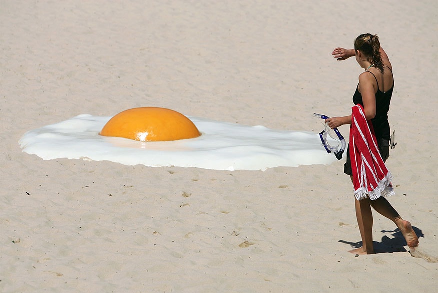 A woman approaches an artwork called