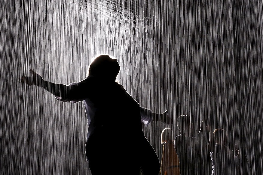 People walk through the Rain Room at the Los Angeles County Museum of Art (LACMA) in Los Angeles, California, United States. The art installation was created by London-based arts collective Random International and uses 528 gallons of recycled water. (Image: Reuters)