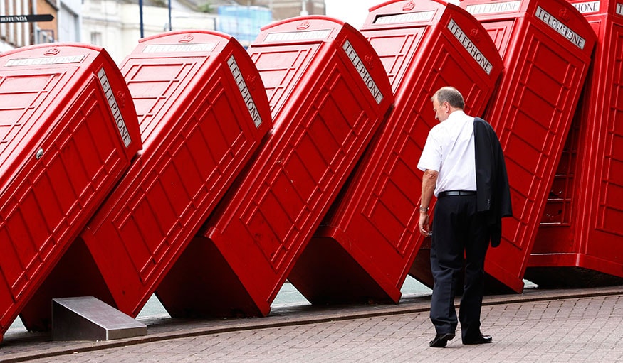 A piece by artist David Mach and entitled 'Out of Order' shows a row of traditional English red phone boxes in Kingston, south of London. (Image: Reuters)