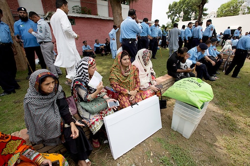 Election officials wait for transportation in Islamabad on Wednesday. (AP)
