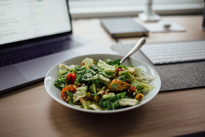 You Eat Meals at Your Desk- Eating is one activity for which you must keep 10 minutes separately instead of eating while working or while watching telly, etc. Research shows that people who eat while working on their gadgets be it a phone, laptop, etc. are not satiated even after the meal.