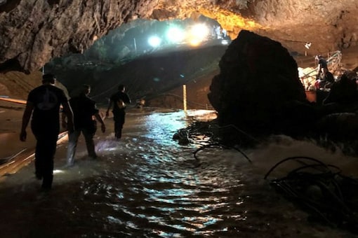 Rescue personnel walk in a cave at the Tham Luang cave complex during a mission to evacuate the remaining members of a soccer team trapped inside, in Chiang Rai, Thailand July 9, 2018, in this photo obtained from social media. MANDATORY CREDIT.  Twitter @elonmusk/via REUTERS