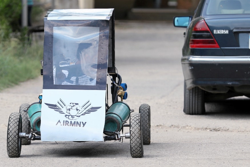 Mahmoud Yasser, mechanical engineering student from Helwan University, drives the air-powered vehicle which he helped design to promote clean energy and battle increasing gas prices, in Cairo, Egypt. (Image: Reuters)