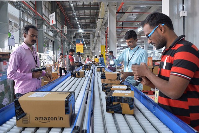 Amazon employees scan packages at the firm's Fulfilment Centre in Bengaluru. (Image: AFP) 
