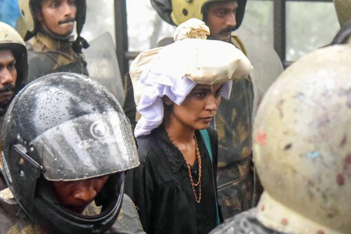 File photo of October 2018 showing activist Rehana Fathima being escorted by the police to Sabarimala Temple, Kerala. (PTI)