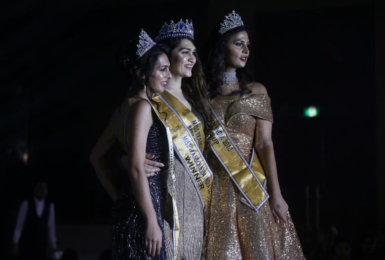 Winner of Miss Transqueen India 2018 beauty pageant Vina Sendre (C) first runner up Sanya Sood (L) and second runner up Nimitha Ammu pose for photographs in Mumbai. REUTERS