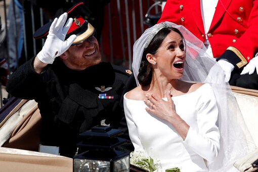 Britain’s Prince Harry and his wife Meghan ride a horse-drawn carriage after their wedding ceremony at St George’s Chapel in Windsor Castle in Windsor, Britain. (Image: Reuters)