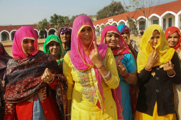 Voters outside a polling booth in Jind.  (PTI Photo) 