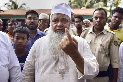 All India United Democratic Front (AIUDF), Badruddin Ajmal, shows his finger marked with indelible ink after casting vote for the second phase of the general elections, at a polling station in Hojai. (Image: PTI)