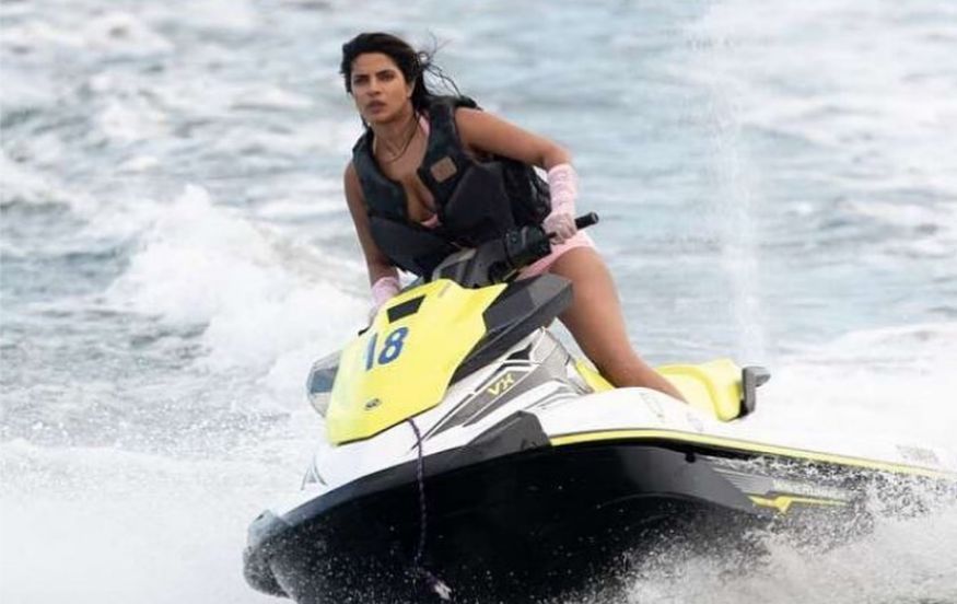  Priyanka Chopra rides water scooter in pink bikini. (Image: Instagram)