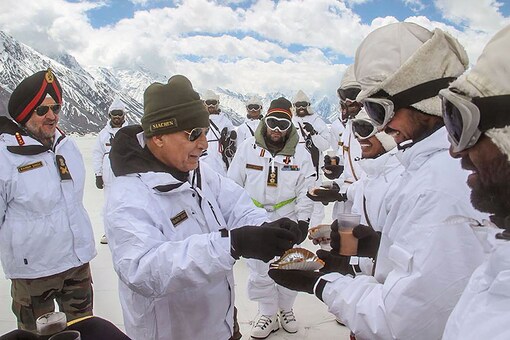 Defence Minister Rajnath Singh with Army jawans during a visit to the world’s highest battlefield, Siachen, in Jammu and Kashmir. (Image: PTI/ File Photo)