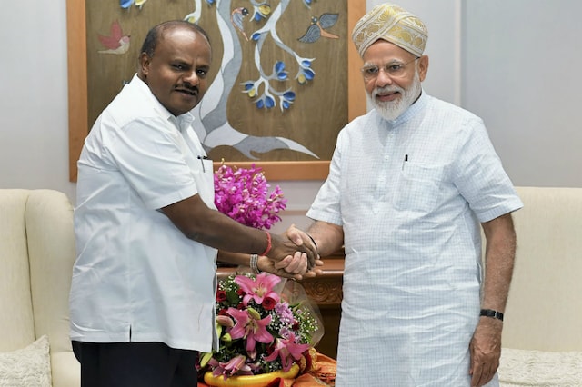 File photo of Prime Minister Narendra Modi being greeted by Chief Minister of Karnataka H.D. Kumaraswamy during a meeting, New Delhi on Saturday. (PTI Photo)