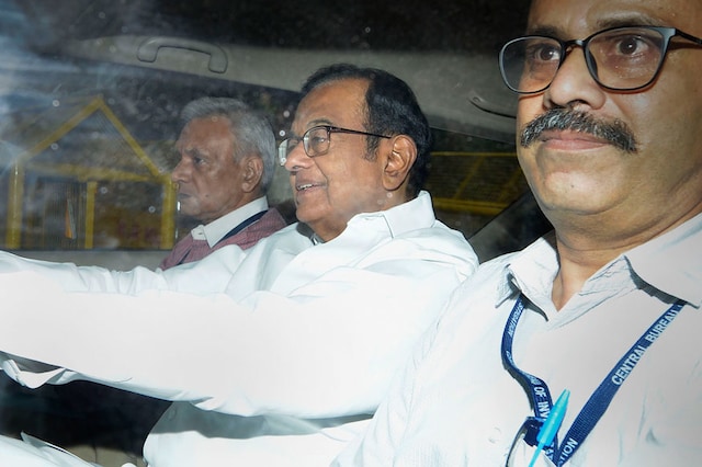 Ramaswamy Parthasarathy can be seen in the red sweater to Chidambaram's right. (Image: PTI)