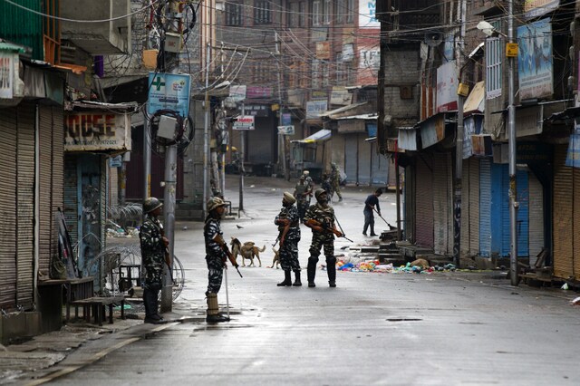 Paramilitary soldiers stand guard on a deserted street during curfew in Srinagar. (AP Photo/Dar Yasin, file)
