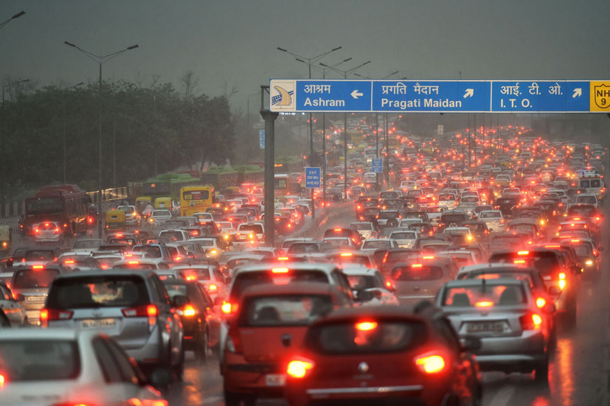 A view of the traffic jam at NH-24 during a heavy downpour, in New Delhi. (Image: PTI)