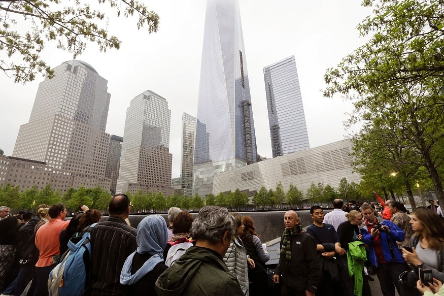 FILE- In this May 15, 2015 file photo, visitors gather near the pools at the 9/11 Memorial in New York. As they have done 17 times before, a crowd of victims' relatives is expected at the site on Wednesday, Sept. 11, 2019 to observe the anniversary the deadliest terror attack on American soil. (AP Photo/Frank Franklin II)
