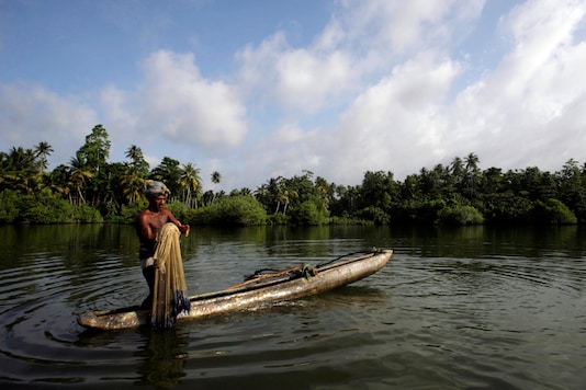 A prawn fisherman prepares his net as he stands in his boat on the Koggala Lake south of Galle (Reuters) A prawn fisherman prepares his net as he stands in his boat on the Koggala Lake south of Galle (Reuters)