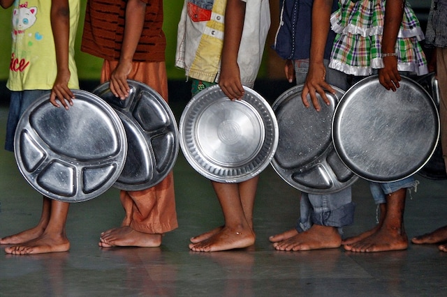 Children holding plates wait in a queue to receive food at an orphanage run by a non-governmental organisation on World Hunger Day, in the southern Indian city of Chennai (Image: REUTERS)