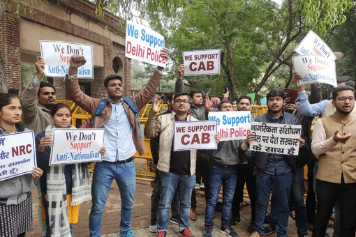 Students with placards supporting CAA. 
