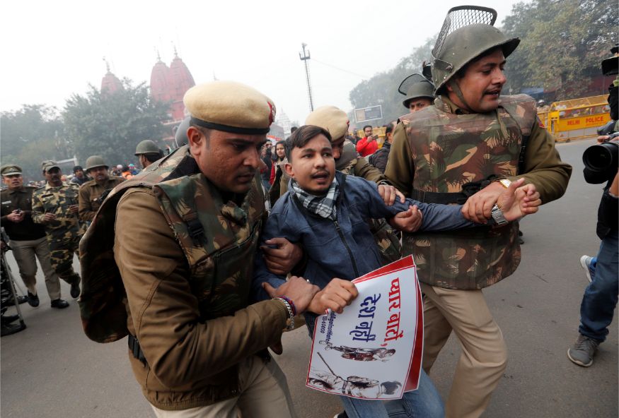 Police officers detain a demonstrator during a protest against a new citizenship law at Red Fort in Delhi. (Image: Reuters)