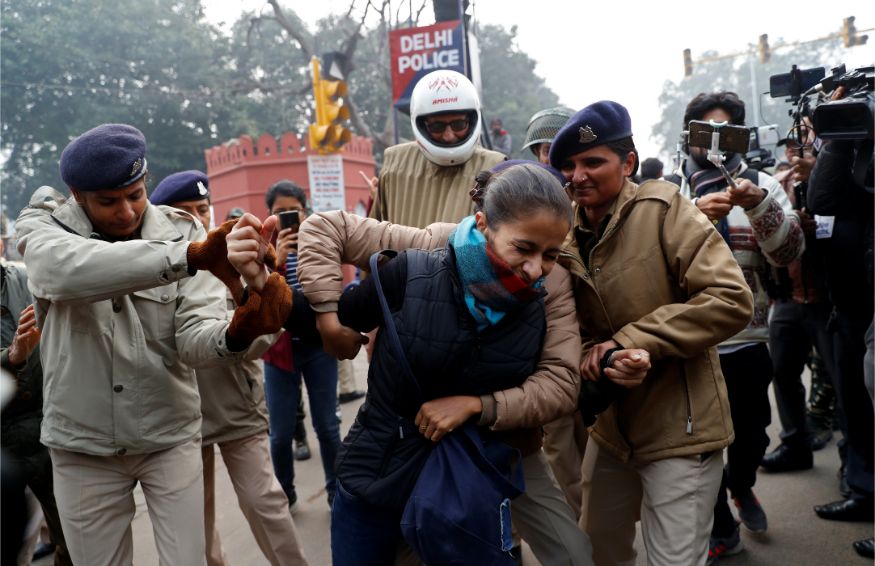 Police officers detain a demonstrator during a protest against a new citizenship law at Red Fort in Delhi. (Image: Reuters)