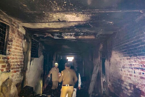 Police and rescue personnel inspect inside the factory at Rani Jhansi Road where a major fire broke out, in New Delhi. (Image: PTI)