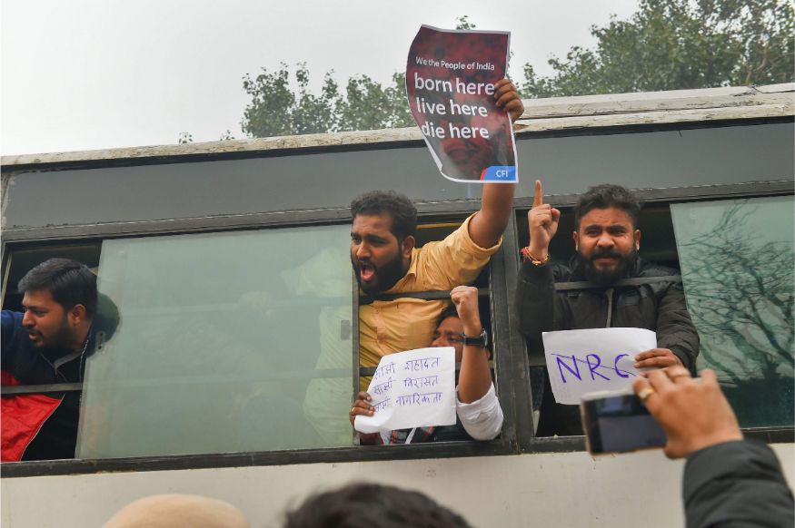 Protestors detained by police for defying prohibitory orders imposed in the area during an anti-Citizenship Act protest, at Red Fort, in New Delhi. (Image: PTI)