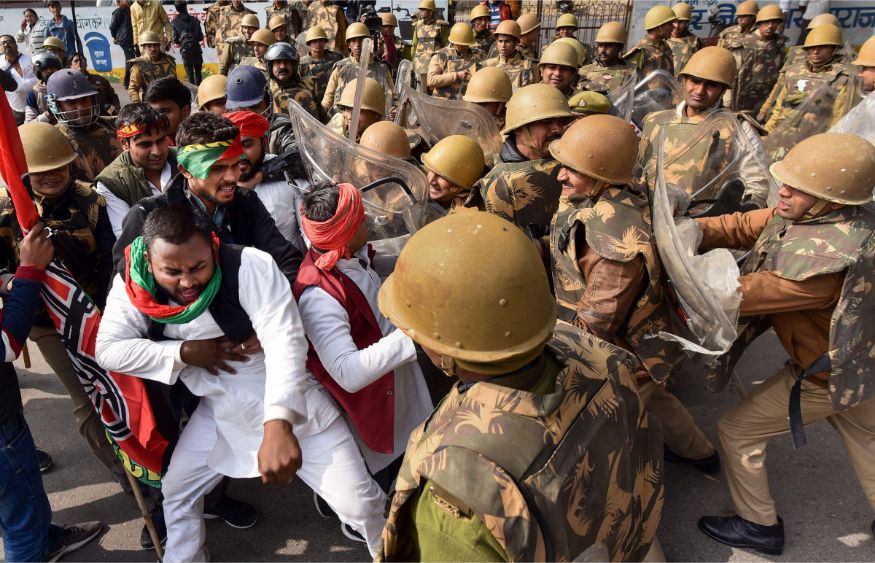 Police personnel detain Samajwadi Party workers during a protest against Citizenship (Amendment) Act, in Prayagraj (Allahabad). (Image: PTI)