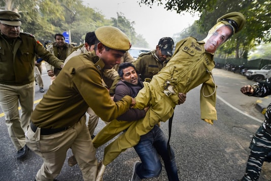 Police personnel detain a member of Indian Youth Congress during a protest against the alleged manhandling of Congress general secretary Priyanka Gandhi by Uttar Pradesh police, at UP Bhawan in Delhi, Sunday, Dec. 29, 2019. (PTI Photo/Ravi Choudhary) Police personnel detain a member of Indian Youth Congress during a protest against the alleged manhandling of Congress general secretary Priyanka Gandhi by Uttar Pradesh police, at UP Bhawan in Delhi, Sunday, Dec. 29, 2019. (PTI Photo/Ravi Choudhary)