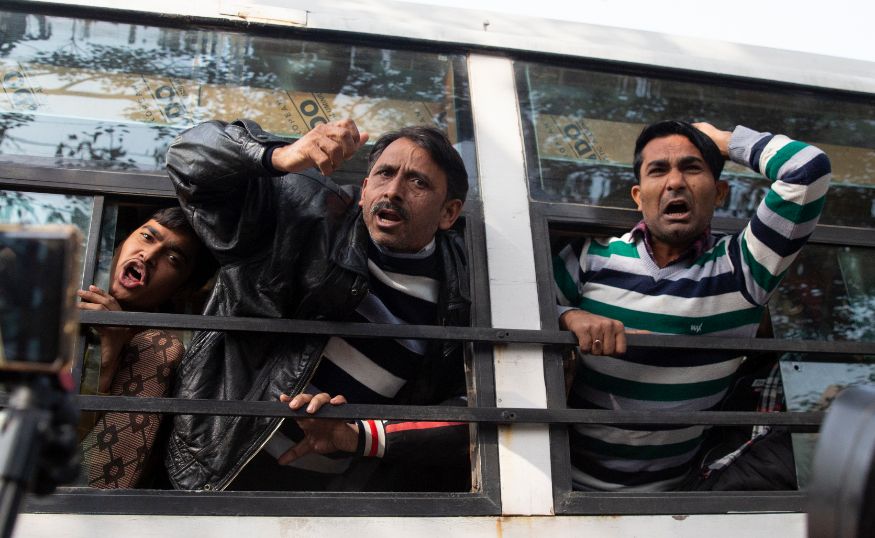 Protesters shout slogans as they are detained outside Uttar Pradesh Bhawan during a protest against violence by police that have arisen during demonstrations against the new citizenship law in the state, in New Delhi. (Image: AP)