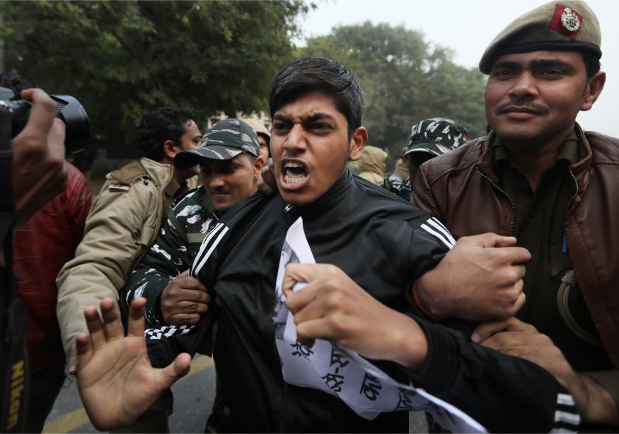 Policemen detain students protesting outside Uttar Pradesh Bhawan during a protest against a new citizenship law and violence by police in the state, in New Delhi. (Image: AP)