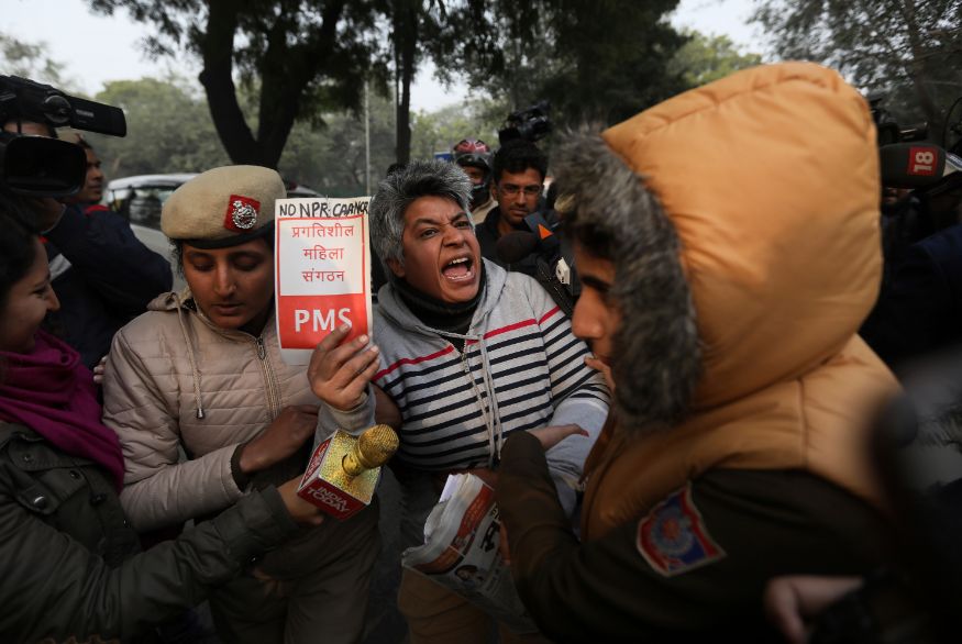 A protesting activist is being detained by a policewoman outside Uttar Pradesh Bhawan during a protest against a new citizenship law and violence by police in the state, in New Delhi. (Image: AP)