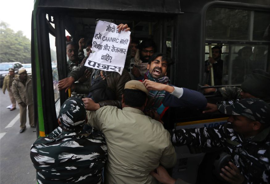 Policemen detain students protesting outside Uttar Pradesh Bhawan against a new citizenship law and violence by police in the state, in New Delhi. (Image: AP)