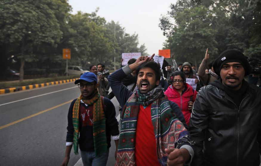 Students shout slogans as they march towards Uttar Pradesh Bhawan during a protest against a new citizenship law and violence by police in the state, in New Delhi. (Image: AP)