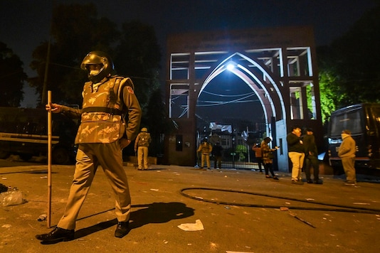 Policemen stand guard near Jamia Millia Islamia following the protests against Citizenship Amendment Act, in New Delhi, on Sunday. (PTI) Policemen stand guard near Jamia Millia Islamia following the protests against Citizenship Amendment Act, in New Delhi, on Sunday. (PTI)