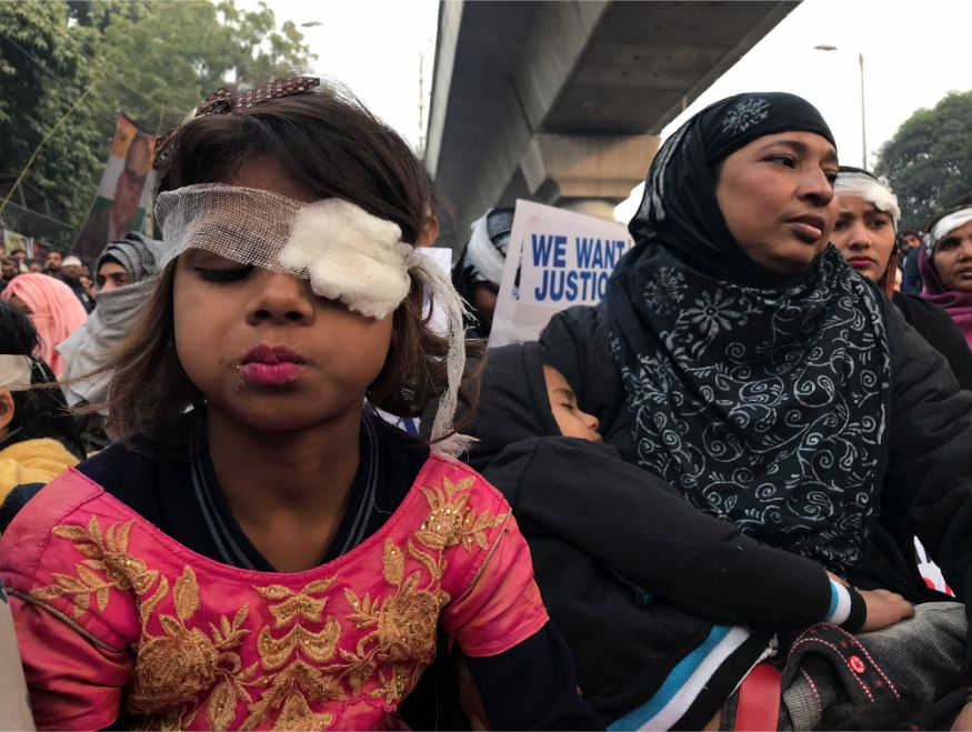 Protesters wearing symbolic bandages in solidarity with a student who lost his eye after being hit by a police baton during December 15 protests gather at Jamia University in New Delhi. (Image: AP)