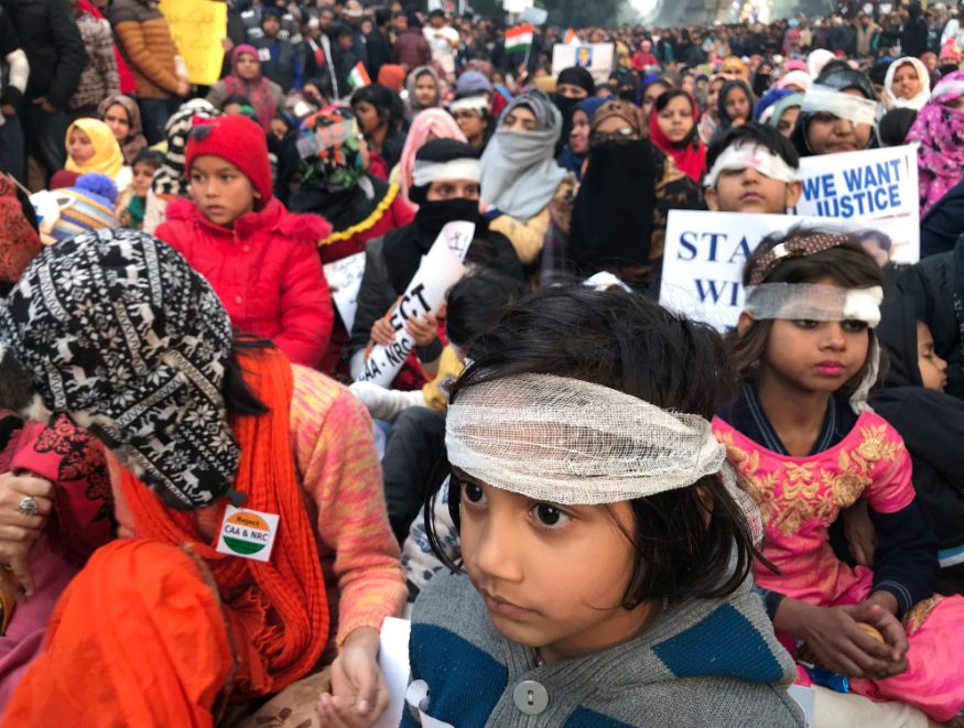 Protesters wearing symbolic bandages in solidarity with a student who lost his eye after being hit by a police baton during December 15 protests gather at Jamia University in New Delhi. (Image: AP)
