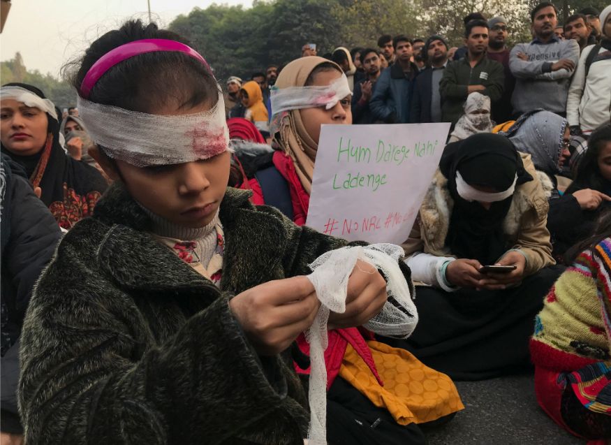 Protesters wearing symbolic bandages in solidarity with a student who lost his eye after being hit by a police baton during December 15 protests gather at Jamia University in New Delhi. (Image: AP)