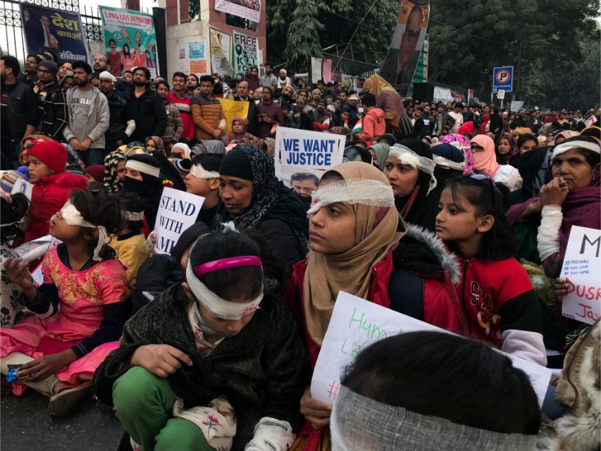 Protesters wearing symbolic bandages in solidarity with a student who lost his eye after being hit by a police baton during December 15 protests gather at Jamia University in New Delhi. (Image: AP)