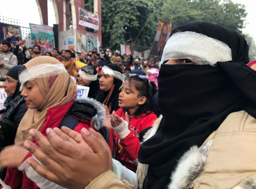 Protesters wearing symbolic bandages in solidarity with a student who lost his eye after being hit by a police baton during December 15 protests gather at Jamia University in New Delhi. (Image: AP)