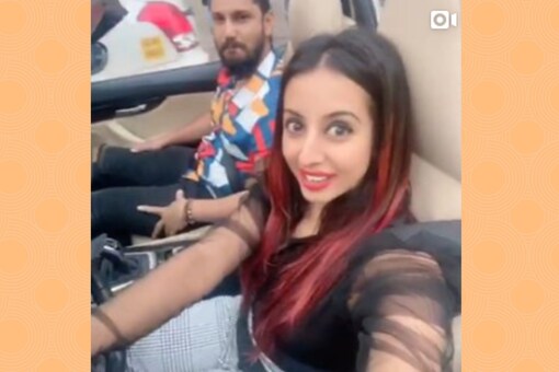 Actress Sanjjana Galrani in a screen grab of a video that shows her driving a convertible car on a busy road and shooting video on her smartphone.

(Image: Sanjjana Galrani's Instagram Account)